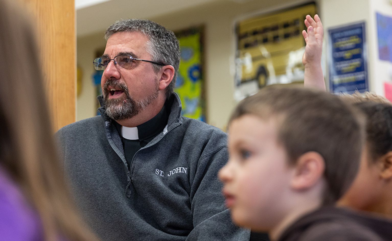 Reverend Anthony J. Smith of St. John school teaches young student